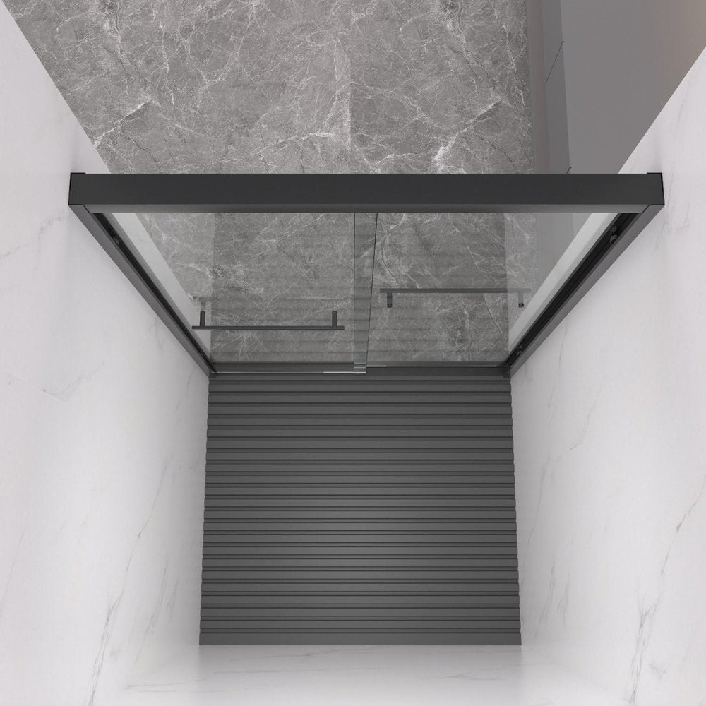 Modern black framed glass shower door with a ribbed dark gray base, set against marble tile walls and floor.