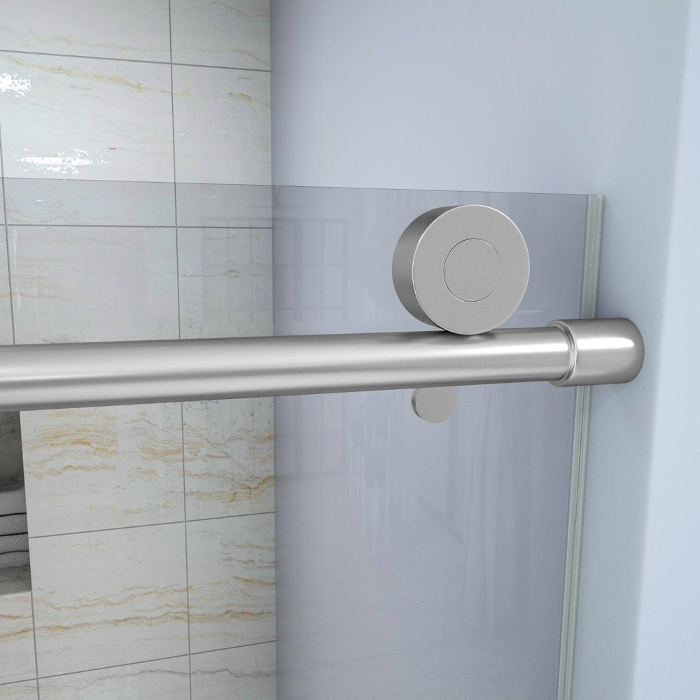 Brushed nickel aluminum shower door handle and roller on a clear glass shower door with tiled background.