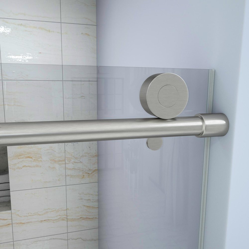 Brushed nickel sliding shower door with clear tempered glass and a brushed nickel handle against a tiled background.