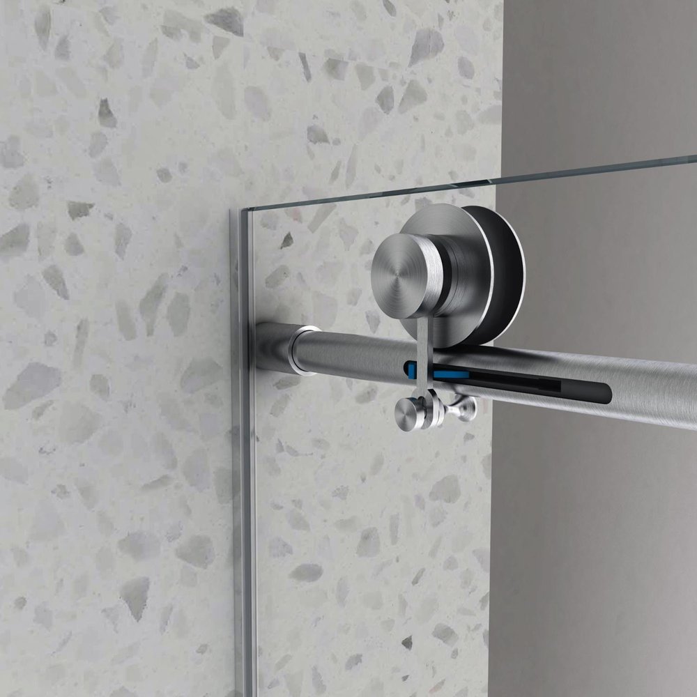 Brushed nickel sliding shower door with clear tempered glass on a terrazzo-style wall.
