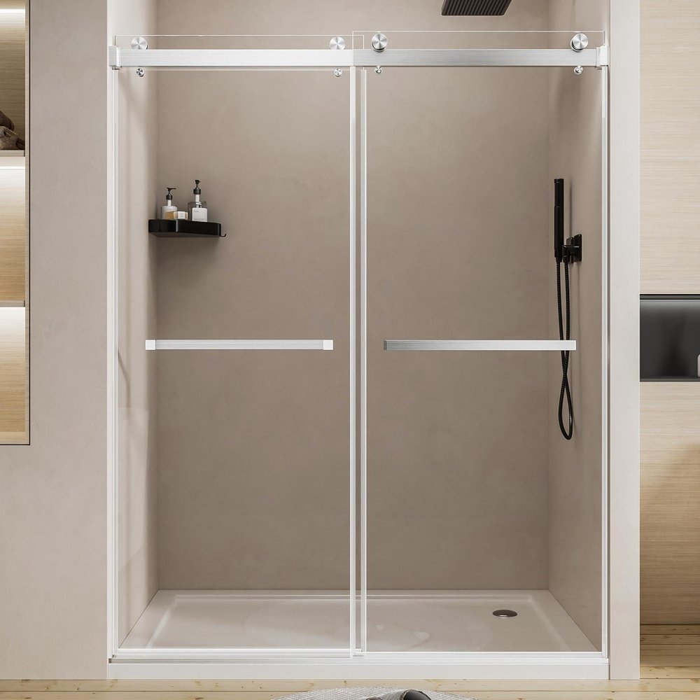 Modern white framed sliding shower door with clear tempered glass and chrome handles in a bathroom.