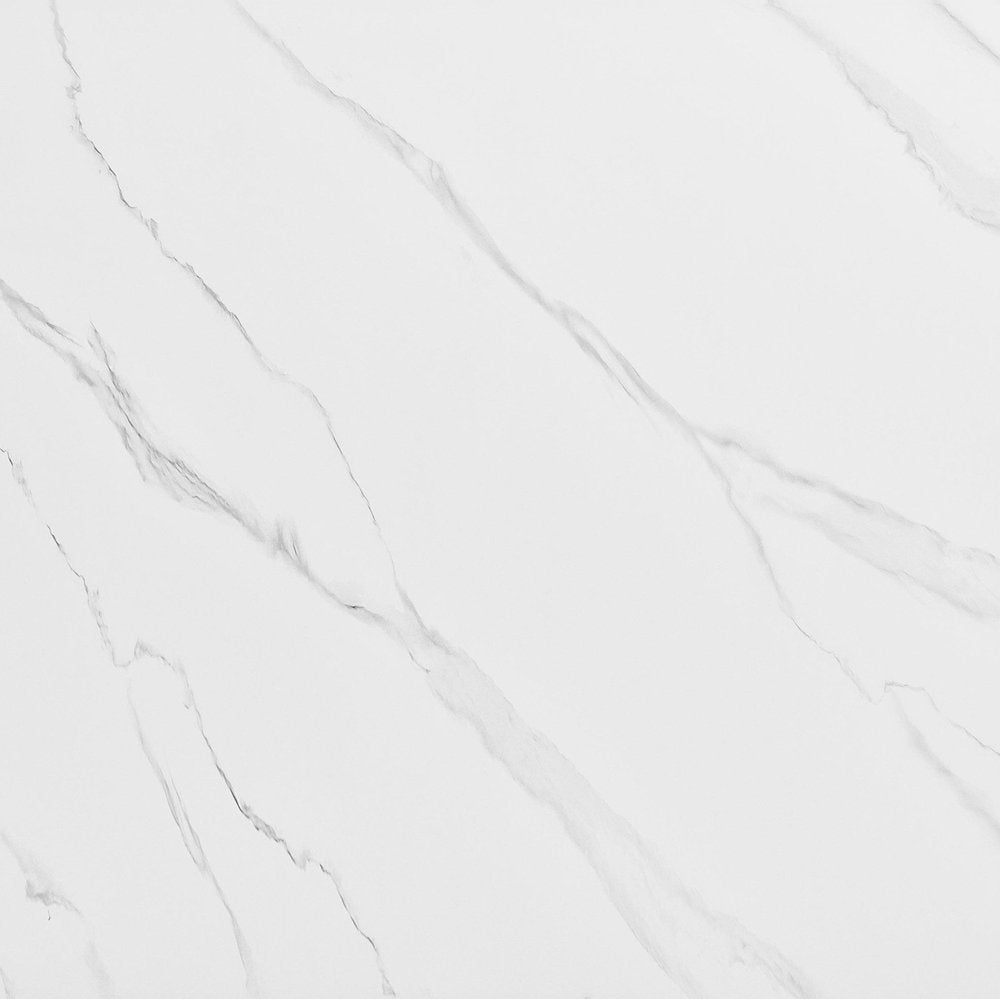 White sintered stone dining table with gray veining on a plain background.