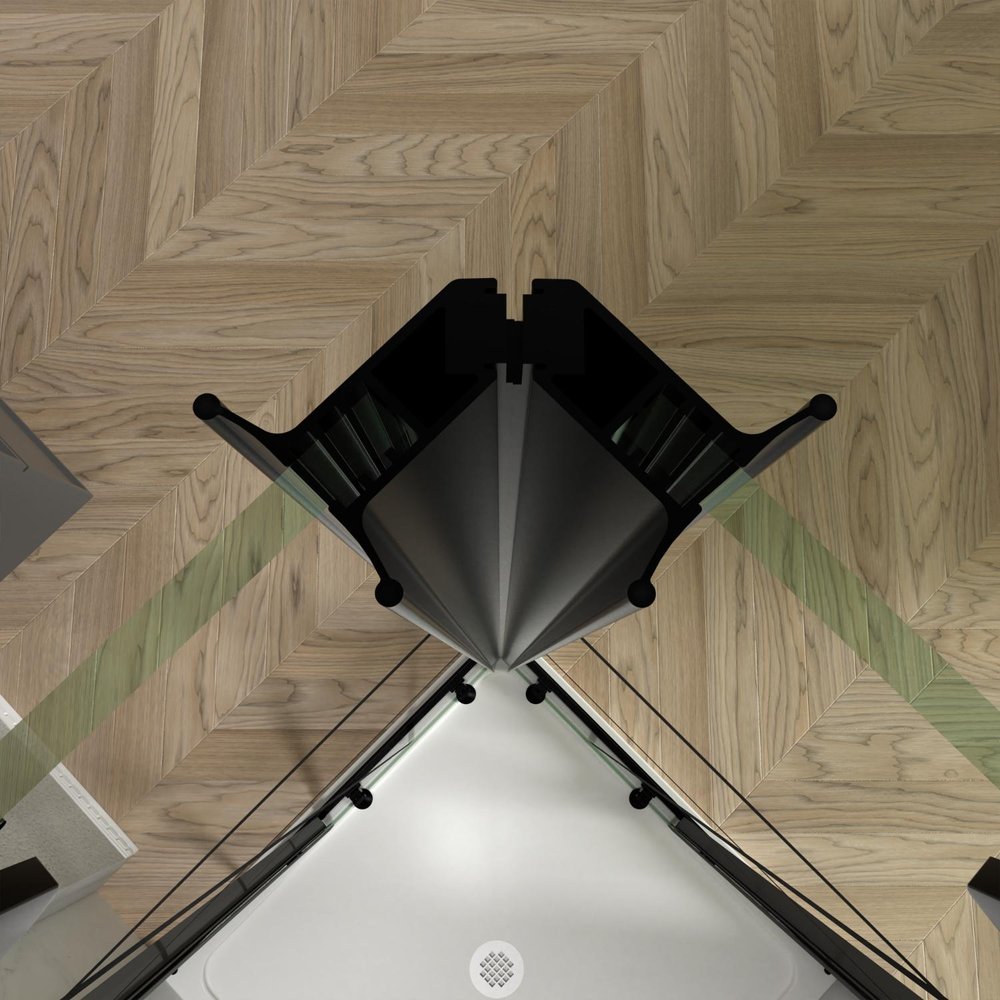 Top-down view of a modern corner shower enclosure with black aluminum frame and clear tempered glass on a light wood herringbone floor.
