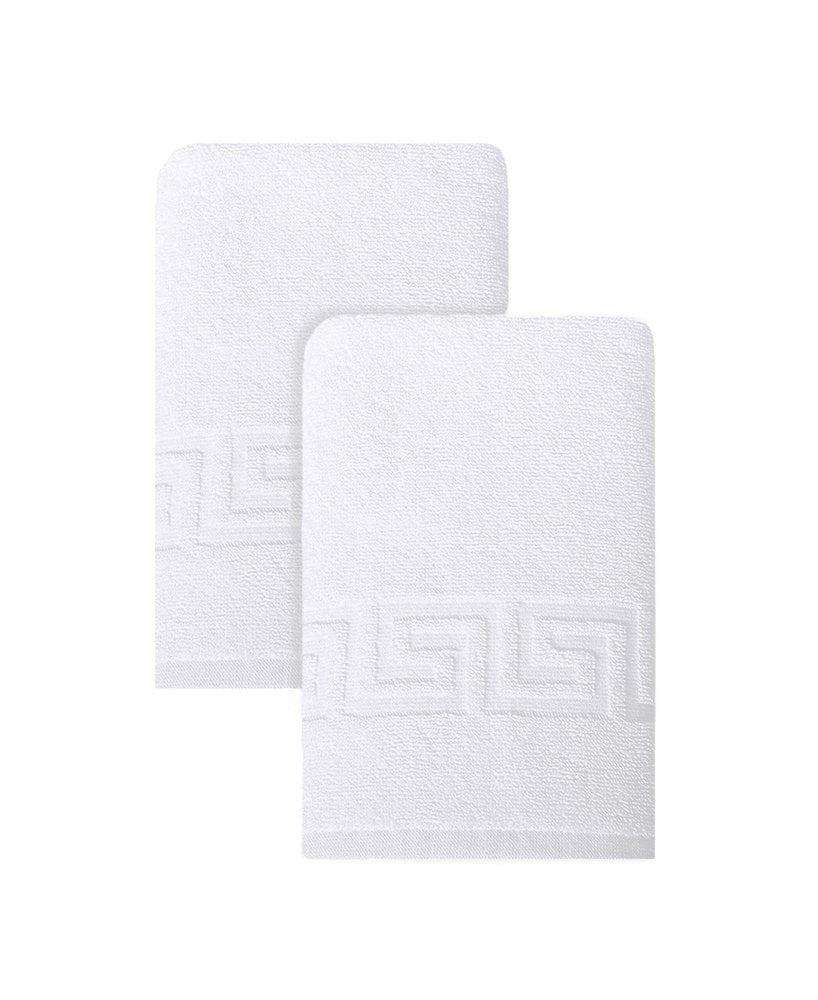 Two white Turkish cotton hand towels with a Greek key pattern on a white background.