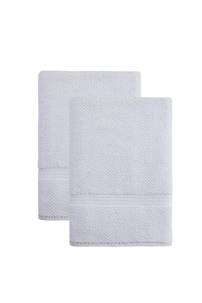 Two white chevron Turkish cotton bath sheets stacked on a white background.