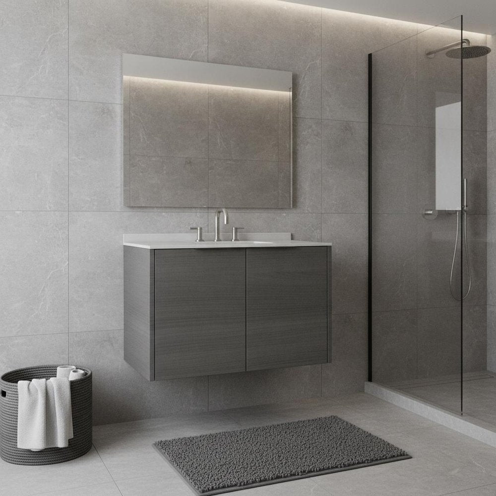 Gray wood floating double door bathroom vanity with white sink and chrome faucet against gray tiled wall.