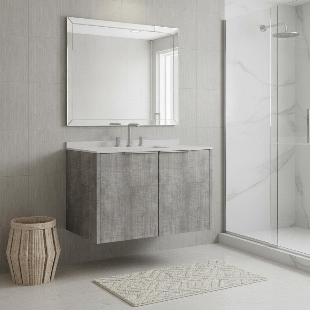 Gray wood floating double door bathroom vanity with white sink and mirror in a tiled bathroom.