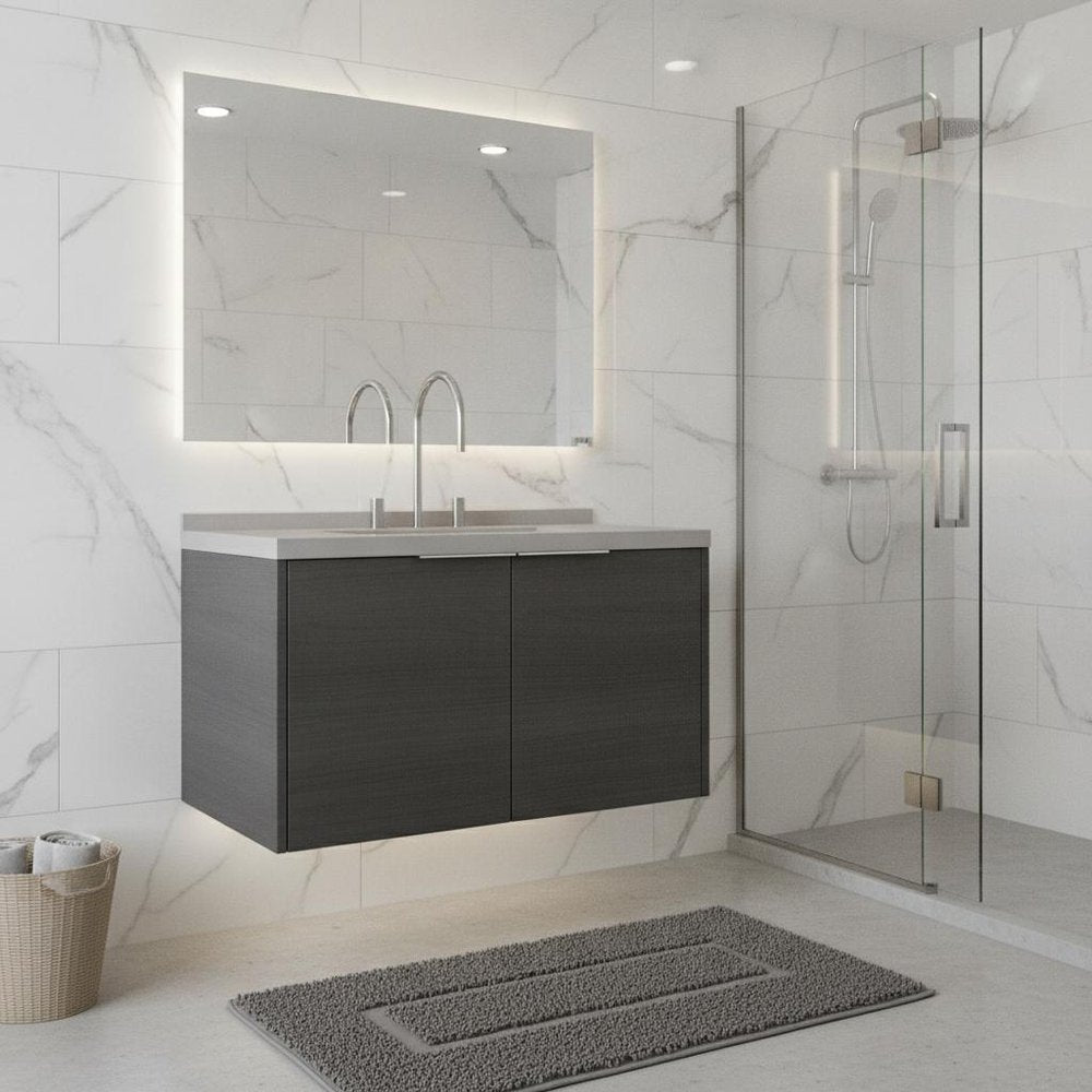 36" gray wood floating double door bathroom vanity with white sink and chrome faucets against a marble tiled wall.