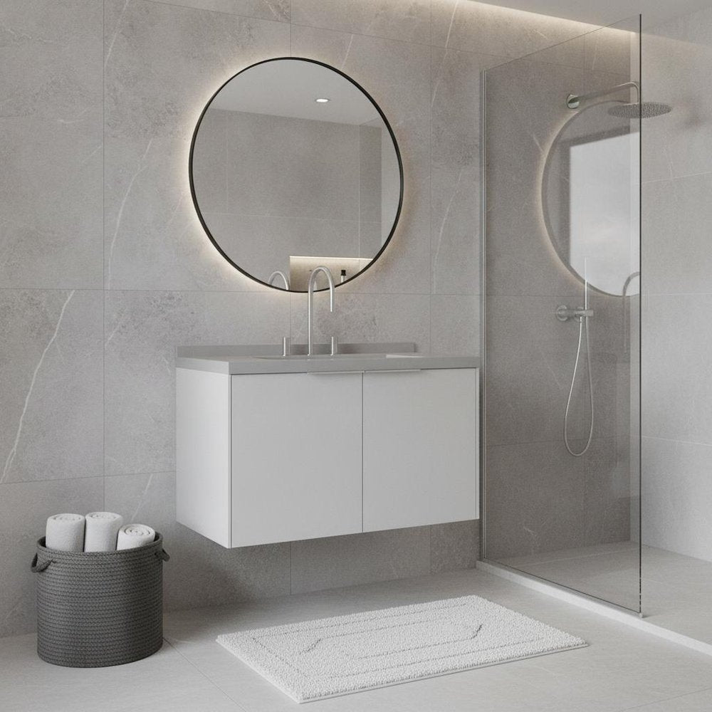 A 36" white wood floating double door bathroom vanity with a sink and a round mirror in a modern bathroom.