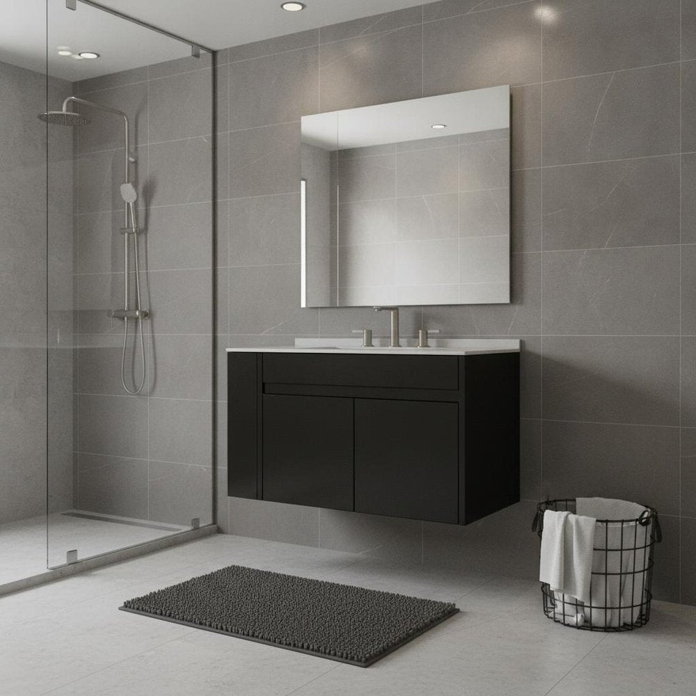 A black wood floating double door bathroom vanity with a white sink and chrome faucet against a gray tiled wall.