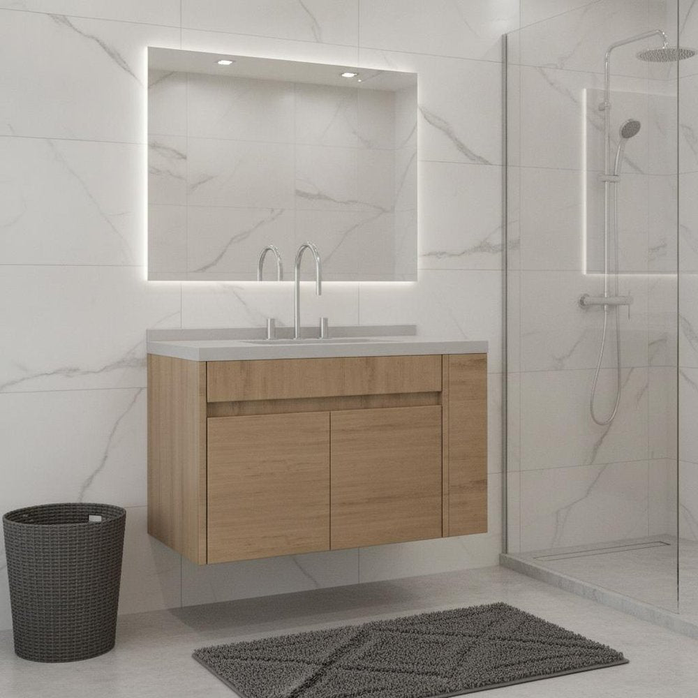 A 36" brown wood floating bathroom vanity with a white sink and a backlit mirror, set against a marble-tiled wall.