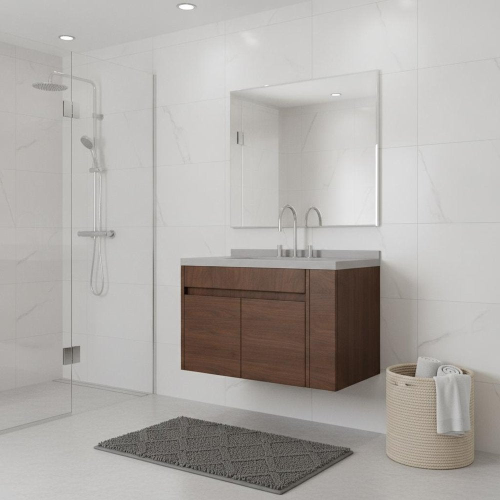 Brown wood floating double door bathroom vanity with white sink and chrome fixtures in a modern bathroom with white tiled walls.
